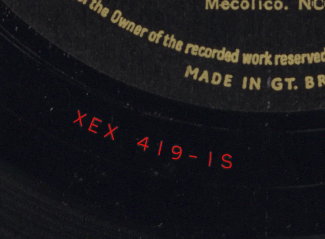 The run-out area and part of the label on side 1 of my copy of Parlophone PMC 1201 (William Clauson, Songs Of The Sea). The stamping is XEX 419-1S. I traced the stamping in red